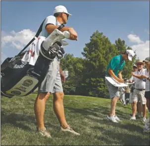  ?? The Associated Press ?? LESSER-KNOWN ZACH JOHNSON: Zach J. Johnson signs autographs during practice for the PGA Championsh­ip Monday at Bellerive in St. Louis. Johnson, a golf pro from the suburbs of Salt Lake City, Utah, will be playing in the tournament that includes the more well-known golfer also named Zach Johnson.