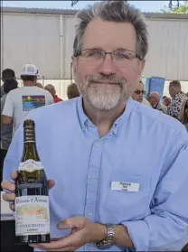  ?? ?? Photo courtesy of Carl Kanowsky Patrick Will of Vintus, pouring some E. Guigal wine at Hospice du Rhone.