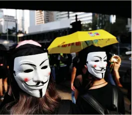  ?? (Jorge Silva/Reuters) ?? ANTI-GOVERNMENT PROTESTERS wearing masks attend a protest in central Hong Kong yesterday.