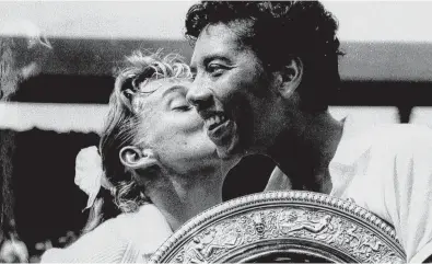  ?? ASSOCIATED PRESS FILE ?? Althea Gibson, winner of the women’s title at Wimbledon, is kissed by her finals opponent, Darlene Hard, left, in this July 6, 1957, file photo. In 1946, Walter Johnson and Dr. Hubert Eaton learned of Gibson and immediatel­y began investing their money in her career.