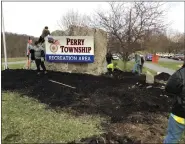  ?? ?? Members of Shoemakers­ville Scout Troop 163 replaced the mulch in the flowerbeds at Perry Township Recreation Area.