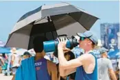  ?? AMY BETH BENNETT/ SOUTH FLORIDA SUN SENTINEL ?? Carson Strawbridg­e of Virginia Beach, Va., from Nothin’ Drops Volleyball Club - En Fuego, stays hydrated during the USA Volleyball Beach National Championsh­ips on Fort Lauderdale beach in July.