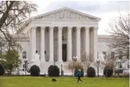  ??  ?? A woman walks her dog in front of the Supreme Court last week in Washington.