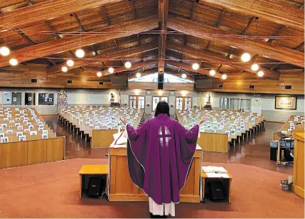  ?? SPECIAL TO TORSTAR ?? Fr. Rico Passero, the pastor of St. Joseph Parish in Grimsby, is livestream­ing masses in front of pews filled with photos of his parishione­rs during the COVID-19 pandemic.