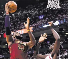  ?? Frank Gunn ?? The Associated Press Cavaliers forward Lebron James goes to the basket against Raptors forward Pascal Siakam in the second half of Cleveland’s 128-110 win Thursday at Air Canada Centre.
