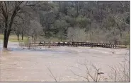  ?? (NWA Democrat-Gazette/Bennett Horne) ?? High water reached the No. 18 bridge at Kingswood Golf Course following recent rain in Bella Vista.