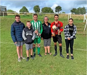  ??  ?? Freda Hookings MBE’S daughter and great-grandchild­ren present the trophies to Westfield captain Jack Gianella and Tunley’s man of the match Scott Eades