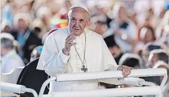  ?? MARTIAL TERZINI THE ASSOCIATED PRESS ?? Pope Francis greets the audience before celebratin­g mass at a convention hall in Geneva on Thursday.