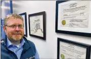  ?? MARK THIESSEN/AP ?? Attorney Scott Kendall stands next to the State of Alaska certificat­e for the election reforms he helped author in a successful ballot initiative.