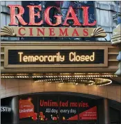  ?? PHOTO BY EVAN AGOSTINI/INVISION/AP ?? Regal Cinemas on 42nd Street is temporaril­y closed due to COVID-19on March 5, 2021, in New York. Regal Cinemas, the second largest movie theater chain in the U.S., will reopen beginning April 2, its parent company, Cineworld Group, announced Tuesday.