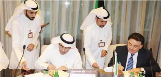  ??  ?? KUWAIT: The Public Authority for Housing Welfare’s Director Bader General Bader Al-Wugayan (left) signs the agreement.— KUNA