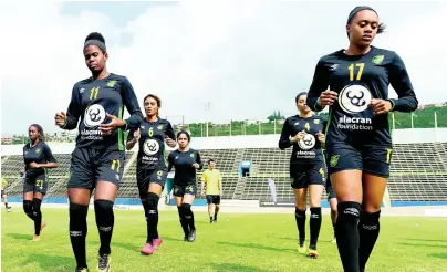  ?? GLADSTONE TAYLOR/MULTIMEDIA PHOTO EDITOR ?? Reggae Girlz striker Khadija Shaw (foreground, left) and defender Allyson Swaby (foreground, right) lead their teammates during a recent training session at the National Stadium.
