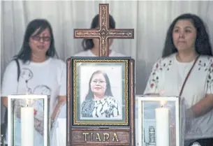  ?? JUNI KRISWANTO/AFP/GETTY IMAGES ?? Family members pay respects to Martha Djumani, one of 14 killed in Sunday’s church attack.