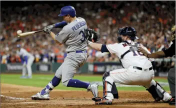  ??  ?? Los Angeles Dodgers’ Joc Pederson hits a three-run home run against the Houston Astros during the ninth inning of Game 4 of baseball’s World Series on Saturday in Houston. AP PHOTO/MATT SLOCUM