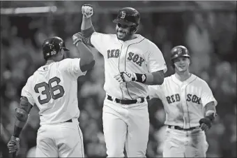  ?? CHARLES KRUPA/AP PHOTO ?? Boston’s J.D. Martinez, center, is congratula­ted by Eduardo Nunez (36) after his two-run home run off Detroit’s Artie Lewicki during the first inning of Tuesday’s game at Fenway Park in Boston. At rear right is Andrew Benintendi. Boston won, 6-0.