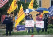  ??  ?? PROTESTERS hold up signs and flags outside the closed Chinese consulate in Houston on July 24. China is fast becoming an issue in election-bound U.S.