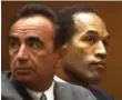  ??  ?? 1994 O.J. Simpson, right, and defence attorney Robert Shapiro during the infamous murder trial.