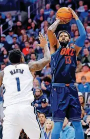  ?? [PHOTO BY SARAH PHIPPS, THE OKLAHOMAN] ?? Oklahoma City’s Paul George shoots over Memphis’ Jarell Martin during Sunday night’s game at Chesapeake Energy Arena. George scored a team-high 33 points to lead the Thunder to a 110-92 victory.