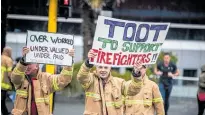  ?? Photo / NZME ?? Hosed-off about their employment conditions, New Zealand Profession­al Firefighte­rs Union members hit the streets in August to protest.