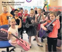  ??  ?? Pop stars Kids just loved trying the instrument­s