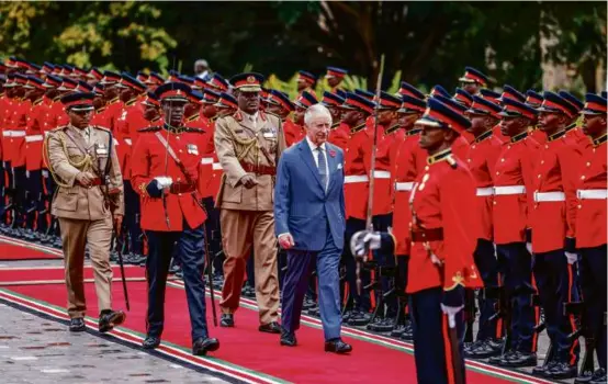  ?? LUIS TATO/AFP VIA GETTY IMAGES ?? Britain’s King Charles III inspected the Guard of Honor as he arrived at the State House in Nairobi, Tuesday.