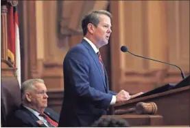  ?? / aP ?? Georgia Gov. Brian Kemp, right, speaks to members of the Georgia House as House Speaker David Ralston looks on during the final 2019 legislativ­e session at the State Capitol ON Tuesday in Atlanta.