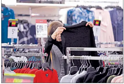  ??  ?? A shopper checks out the merchandis­e last fall at a J.C. Penney store in Seattle. For January, higher prices for apparel helped fuel the biggest month-over-month rise in the consumer price index since September.