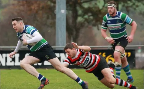  ??  ?? David Shannon on the move for Gorey after a missed tackle by Enniscorth­y’s Richard Dunne.