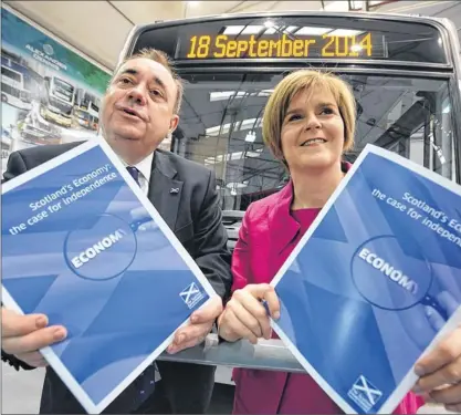  ?? Picture: Jeff J Mitchell ?? DRIVING FORWARD: Alex Salmond and Nicola Sturgeon launched their economic report at Alexander Dennis coach builders in Falkirk.