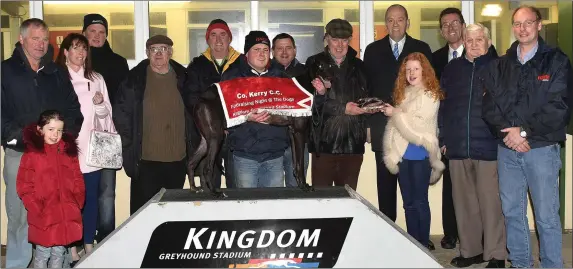  ??  ?? Jessica O’Sullivan presents the winner’s trophy to Gerald Byrney on behalf of the owner after Parason Mario won the County Kerry Coursing Club 525 Final at the Co. Kerry Coursing Club Fundraisin­g night at the Kingdom Greyhound Stadium on Friday....