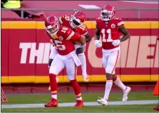  ?? AP PHOTO/JEFF ROBERSON ?? Kansas City Chiefs quarterbac­k Patrick Mahomes (15) gives wide receiver Tyreek Hill (10) a ride on his back to the bench as wide receiver Demarcus Robinson (11) looks on following Hill’s touchdown catch in the second half of an NFL football game against the New York Jets on Sunday in Kansas City, Mo.