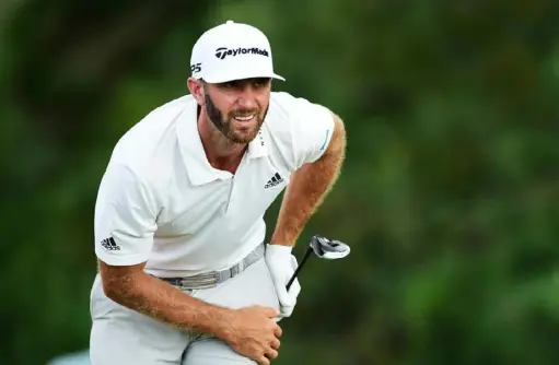  ?? Jared C. Tilton/ Getty Images ?? Dustin Johnson watches his shot from the 16th tee in the second round of The Northern Trust. A 4- under 67 put him at 12- under in the first event of the FedEx Cup playoffs. “I think it’s going to be a good weekend,” he said.