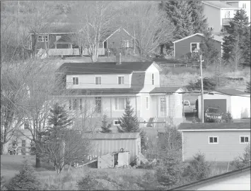  ?? — Telegram file photo ?? The two-storey green and white home at the centre of the picture was the scene of the standoff between police and Leo Crockwell in Bay Bulls.