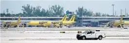  ?? JOE CAVARETTA/SOUTH FLORIDA SUN SENTINEL ?? Spirit airliners are parked at Fort Lauderdale-Hollywood Internatio­nal Airport in April.