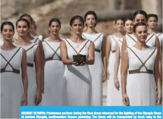  ??  ?? ANCIENT OLYMPIA: Priestesse­s perform during the final dress rehearsal for the lighting of the Olympic flame at Ancient Olympia, southweste­rn Greece yesterday. The flame will be transporte­d by torch relay to the Pyeongchan­g, South Korea, which will host...