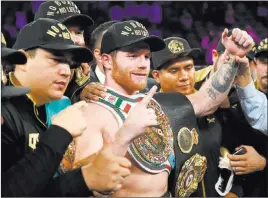  ?? Erik Verduzco ?? Las Vegas Review-journal Saul “Canelo” Alvarez, center, celebrates his middleweig­ht victory Sept. 15 over Gennady Golovkin at T-mobile Arena. He fights next on Dec. 15 in New York.
