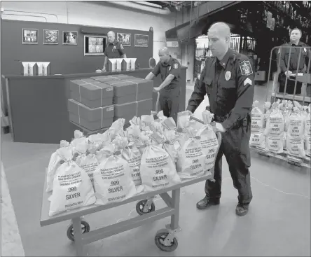  ??  ?? Q ARKANSAS RESIDENTS CASH IN: It’s like a modern day Gold Rush. Everyone’s scrambling to get their hands on the heavy, Jumbo Silver Ballistic Bags pictured above before they’re all gone. That’s because residents who find their zip code printed in today’s publicatio­n are cashing in on the lowest ever State Minimum price set for the next 2 days by the Federated Mint.