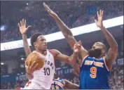  ?? The Canadian Press ?? Toronto Raptors guard DeMar DeRozan (10) drives the net against New York Knicks centre Kyle O’Quinn (9) during first-half NBA action in Toronto on Friday.