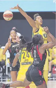  ?? CHRIS O’MEARA ?? Storm center Mercedes Russell, top, blocks a shot by Aces guard Jackie Young, front, on Friday in Game 1 of the WNBA Finals in Bradenton, Fla.