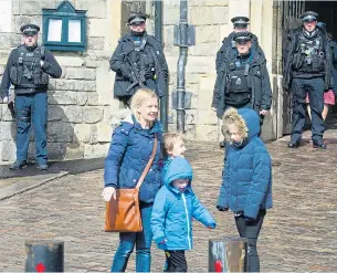  ?? Pictures: TIM CLARKE ?? Visitors to Windsor yesterday see the security measures, steel barriers and armed police, ahead of the wedding