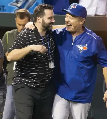  ?? KEITHALLIS­ONPHOTO.COM ?? Jays GM Alex Anthopoulo­s and manager John Gibbons take it all in after Toronto won the AL East Wednesday.