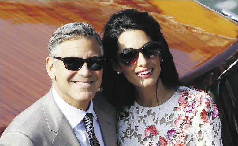  ?? PIERE TEYSSOT / AFP / Gett
y Imag
es ?? George Clooney and Amal Alamuddin stand on a water taxi on the Grand Canal on Sunday in Venice, above and top photo. The Hollywood star and the noted human-rights lawyer were married Saturday in a ceremony presided over by a former mayor of Rome before...