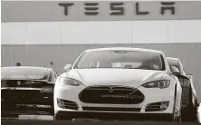  ?? David Zalubowski / Associated Press ?? An analyst calls it “very ironic” for lawmakers to consider a fee against electric vehicles with Tesla building its plant in Austin.