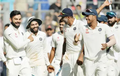  ??  ?? MUMBAI: India captain Virat Kohli (L) celebrates with Ravindra Jadeja (2nd L), Ravichandr­an Ashwin (3rd R) and their teammates during a victory lap after winning the fourth Test cricket match against England at the Wankhede stadium in Mumbai yesterday....