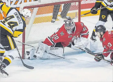  ?? BOB TYMCZYSZYN THE ST. CATHARINES STANDARD ?? Niagara goaltender Stephen Dhillon (30) blocks a shot by Hamilton’s Mackenzie Entwistle in Ontario Hockey League playoff action Monday night.