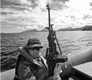  ??  ?? FILIPINO MARINES on rubber boats patrol Ulugan Bay, Palawan, during the “war games” as exercise directors Lt. Gen. Duane Thiessen of the US and Rear Admiral Victor Martir of the Philippine­s congratula­te each other at the formal closing of Balikatan.