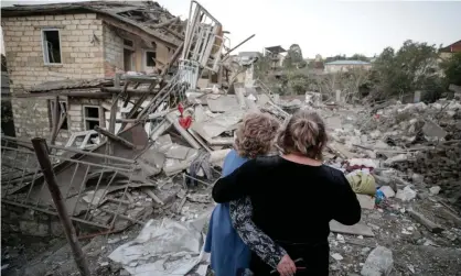  ??  ?? Two women embrace as they examine the ruins of a residentia­l house destroyed in a shelling attack in Stepanaker­t, Nagorno-Karabakh. Photograph: Sergei Bobylev/TASS