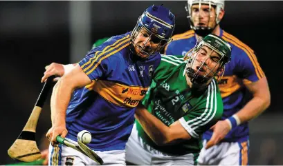  ??  ?? Tipperary’s Jason Forde holds off Limerick’s Sean Finn during their league semi-final in Thurles last month