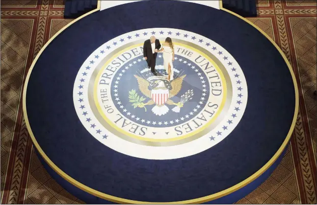  ?? (AFP) ?? In this file photo, US President Donald Trump and First Lady Melania Trump dance during the Armed Services Ball on Jan 20, 2017 in Washington, DC. While the new US president has shown a capacity to change, both his tone and his positions, he has been...