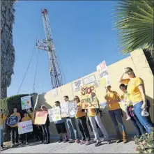  ?? Barbara Davidson
Los Angeles Times ?? ACTIVISTS protest at the Freeport-McMoRan drilling site on Jefferson Boulevard. The company is disputing residents’ claims.